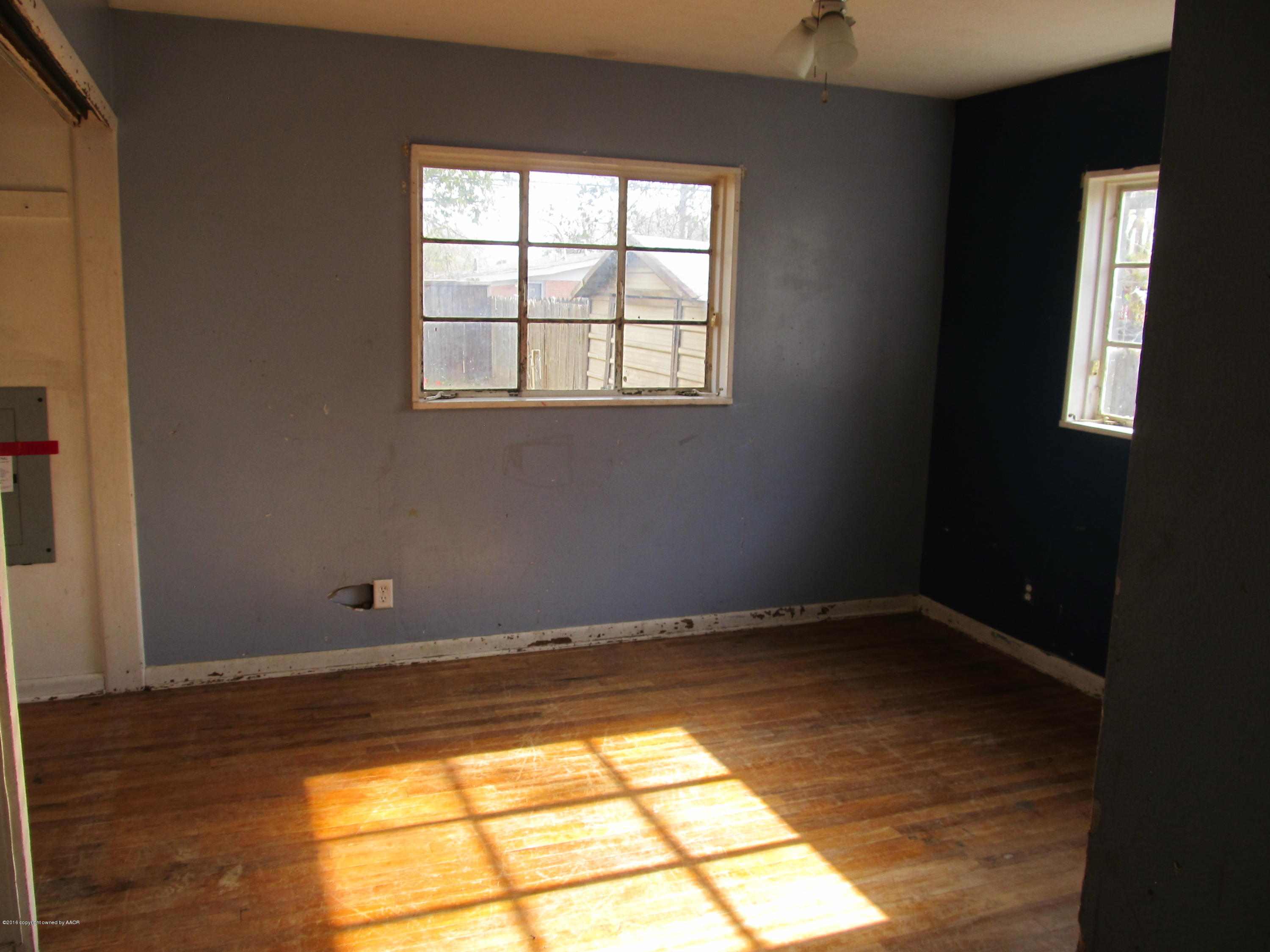 4103 South Bonham Street Amarillo, TX 79110 - Photo 7 of 13 a view of empty room with wooden floor and fan