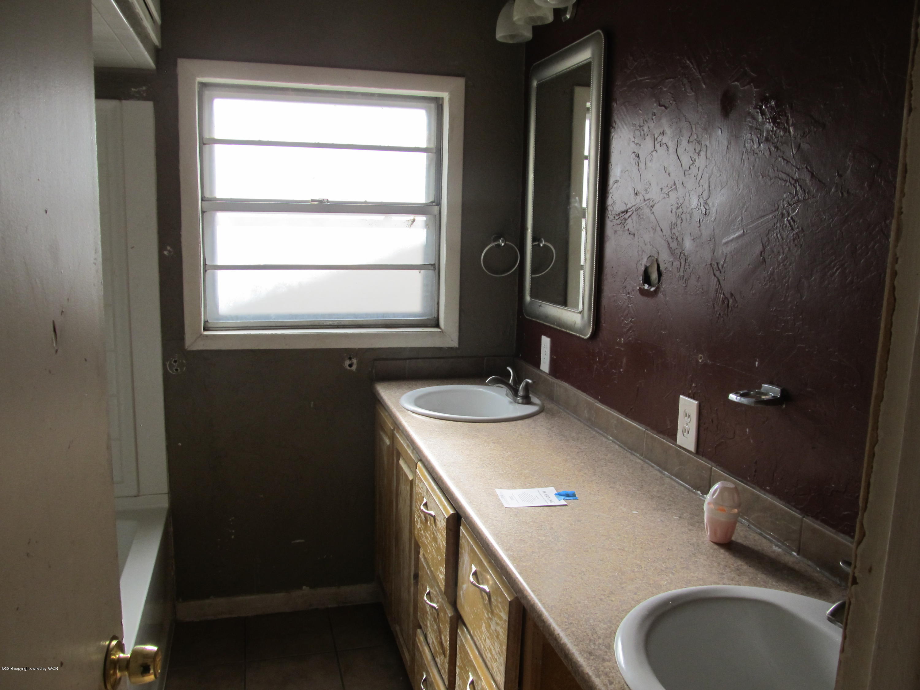 4103 South Bonham Street Amarillo, TX 79110 - Photo 9 of 13 a bathroom with a granite countertop sink toilet and mirror
