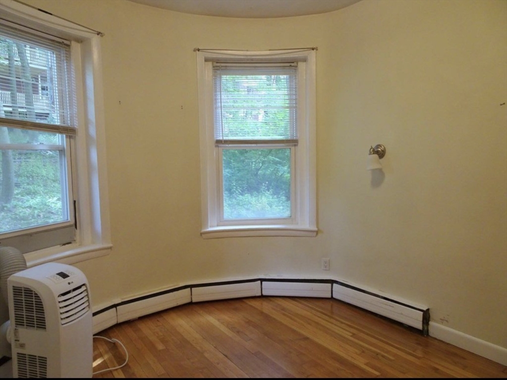 15 University, Unit 22 Brookline, MA 02445 - Photo 4 of 10 a view of an empty room with a window