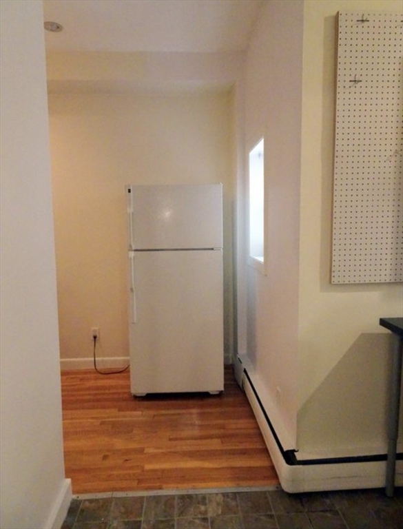 15 University, Unit 22 Brookline, MA 02445 - Photo 8 of 10 a view of a room with wooden floor and white walls