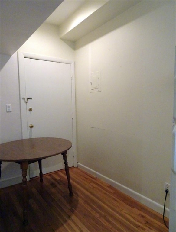 15 University, Unit 22 Brookline, MA 02445 - Photo 9 of 10 a view of a room with wooden floor and a table