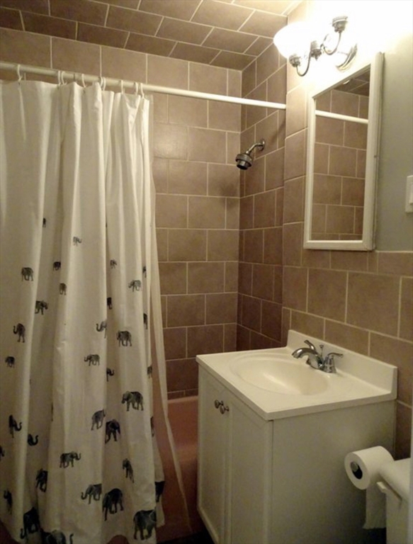 15 University, Unit 22 Brookline, MA 02445 - Photo 10 of 10 a bathroom with a sink and mirror