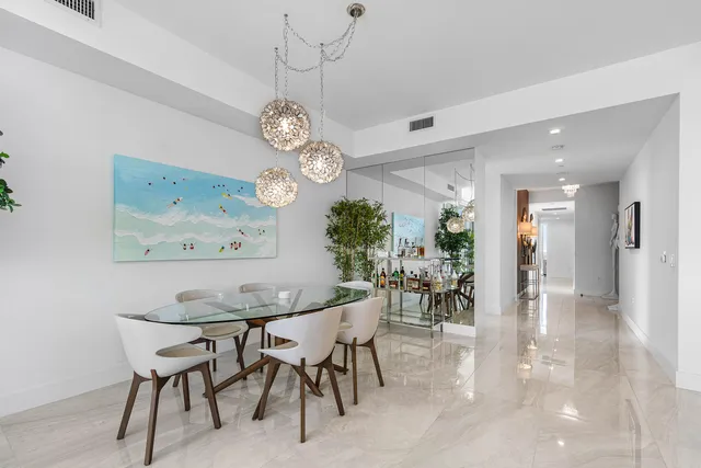 a view of a hallway with bathroom and mirror