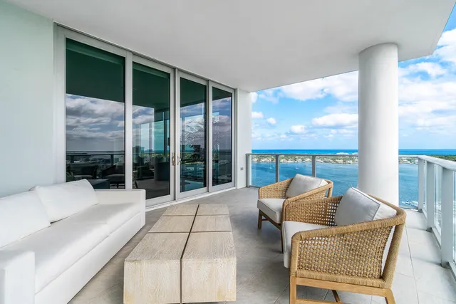 a bedroom with a bed couches and white walls