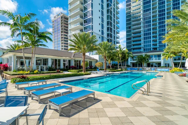 a view of a swimming pool and lounge chairs