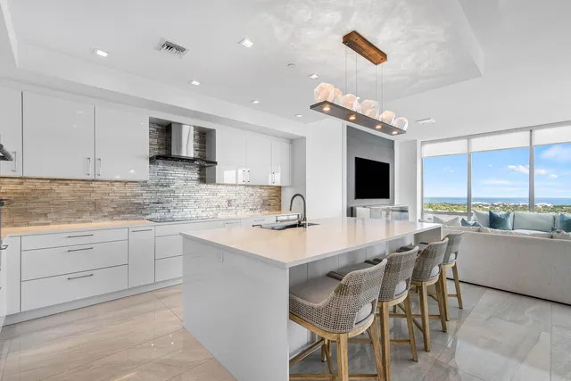 a kitchen with stainless steel appliances kitchen island granite countertop a sink and cabinets