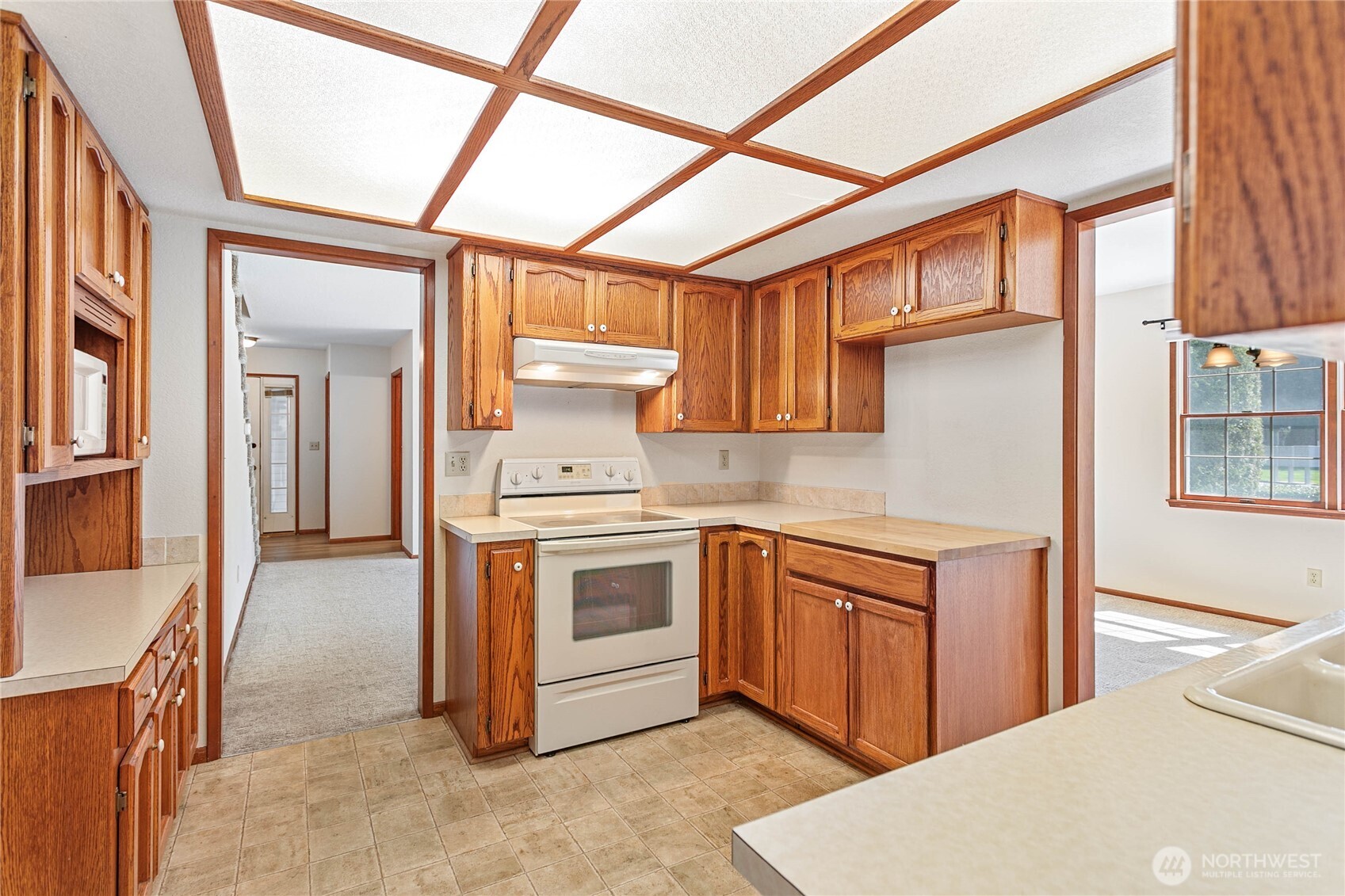1843 Main Street, Unit A1 Lynden, WA 98264 - Photo 11 of 37 a kitchen with stainless steel appliances granite countertop a stove a sink and a refrigerator