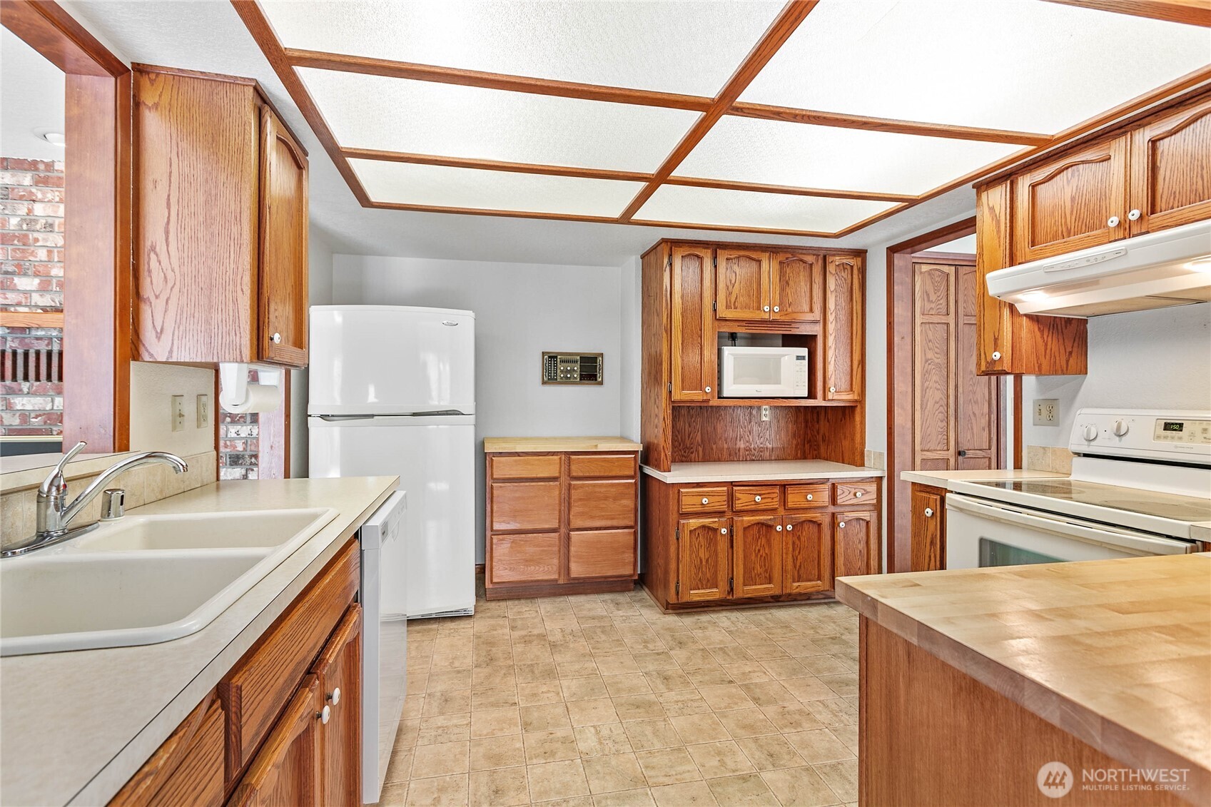 1843 Main Street, Unit A1 Lynden, WA 98264 - Photo 13 of 37 a kitchen with stainless steel appliances granite countertop a sink and a refrigerator