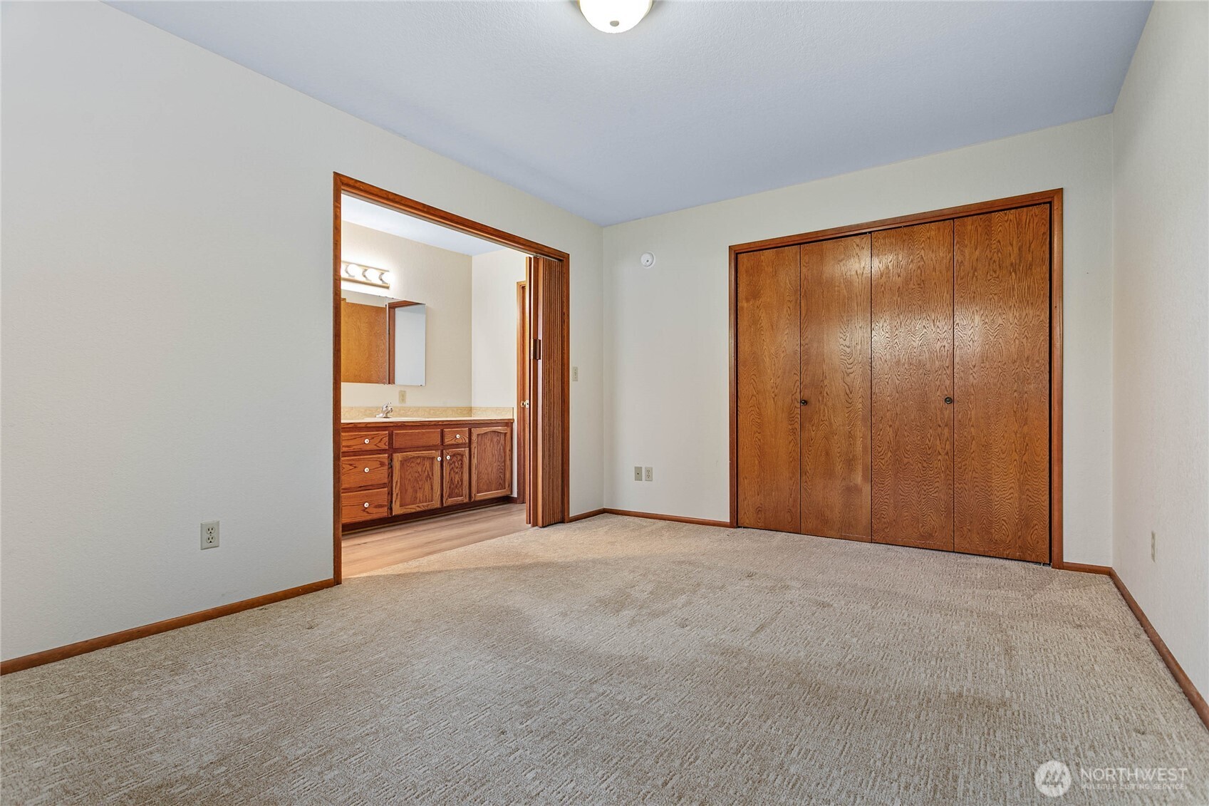 1843 Main Street, Unit A1 Lynden, WA 98264 - Photo 19 of 37 an empty room with closet and mirror