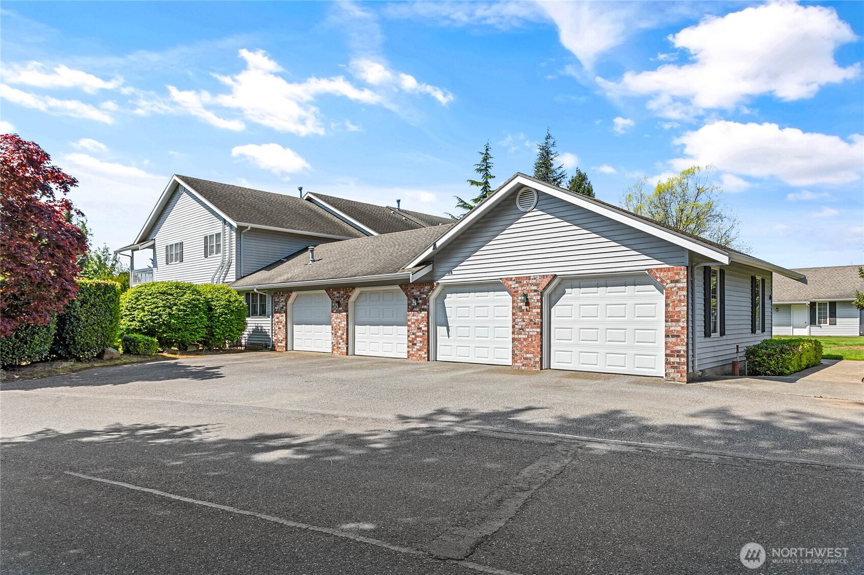 1843 Main Street, Unit A1 Lynden, WA 98264 - Photo 2 of 37 a front view of a house with a yard and garage