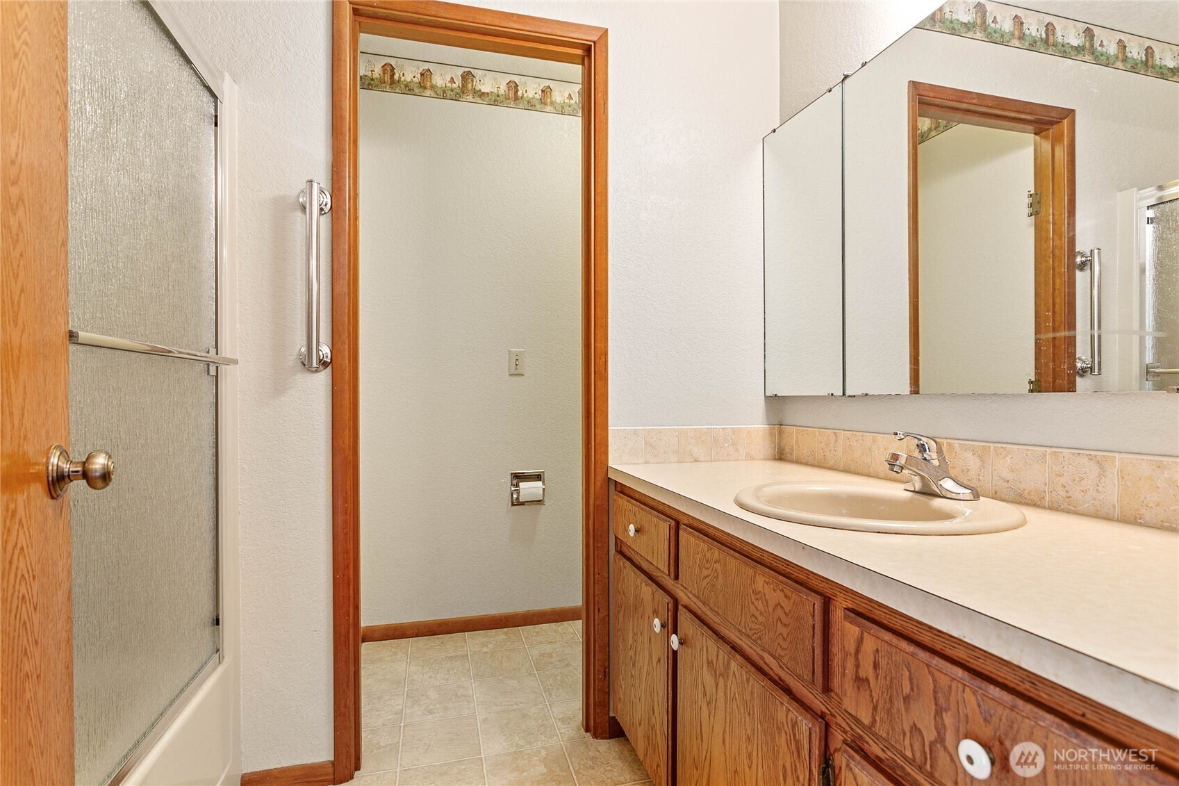 1843 Main Street, Unit A1 Lynden, WA 98264 - Photo 28 of 37 a bathroom with a sink and a mirror