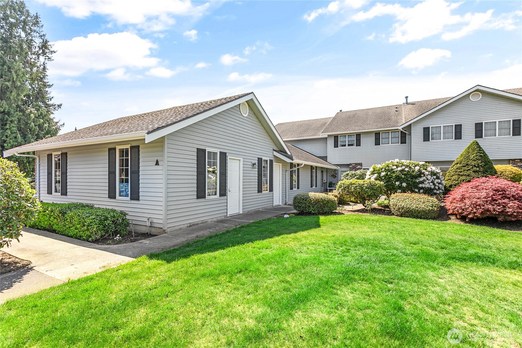 1843 Main Street, Unit A1 Lynden, WA 98264 - Photo 34 of 37 a front view of house with yard and green space