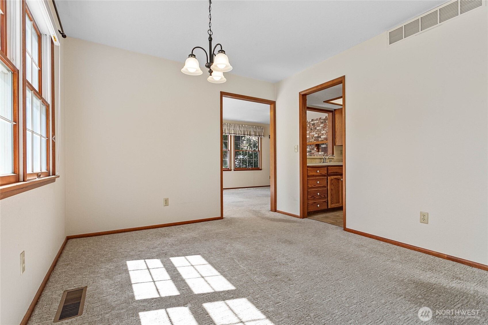 1843 Main Street, Unit A1 Lynden, WA 98264 - Photo 8 of 37 an empty room with windows and chandelier