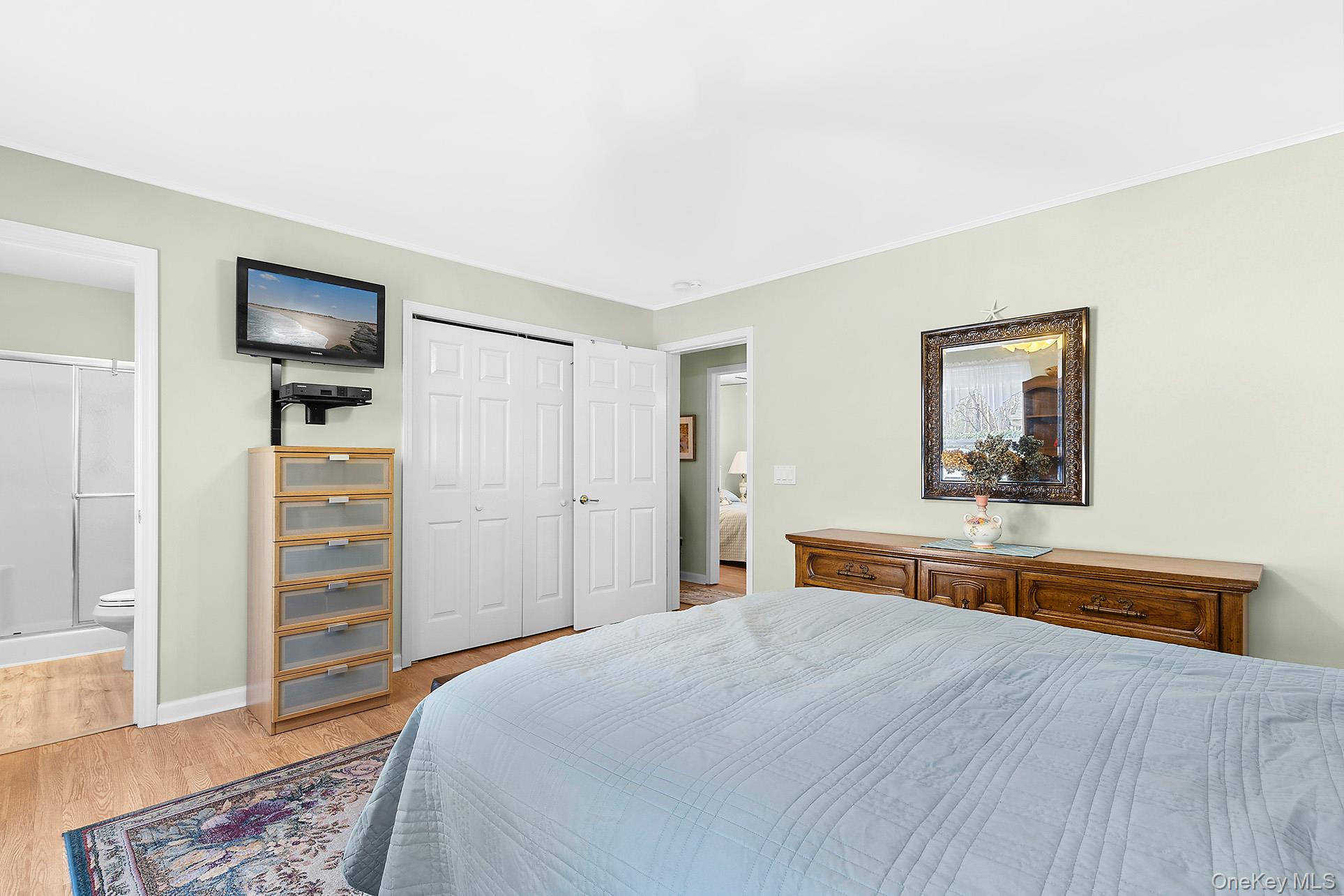 17 Cove View Road Sag Harbor, NY 11963 - Photo 8 of 15 Bedroom featuring light wood-style floors, a closet, and ensuite bathroom