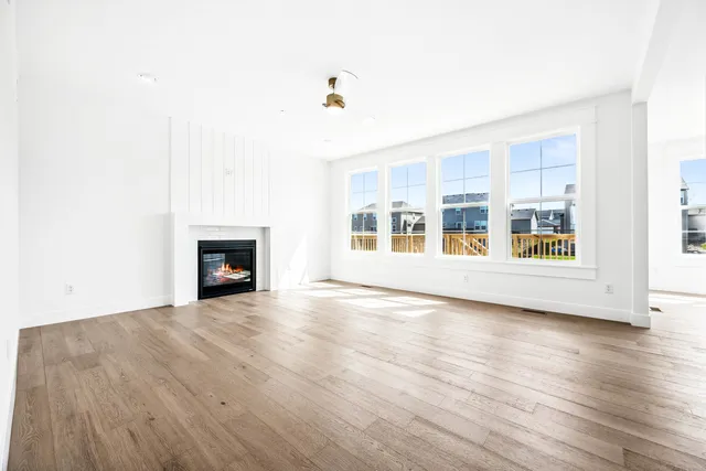 a view of a livingroom with a fireplace and window