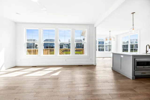 a kitchen with stainless steel appliances a stove a sink a refrigerator and cabinets