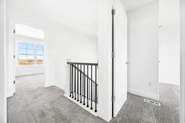 an empty room with a empty space and windows