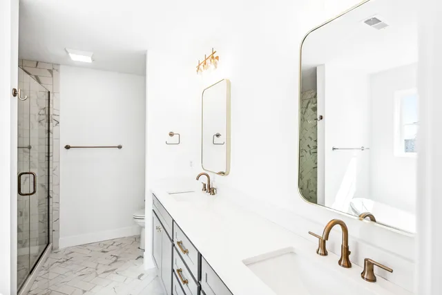 a bathroom with a sink a toilet and a mirror