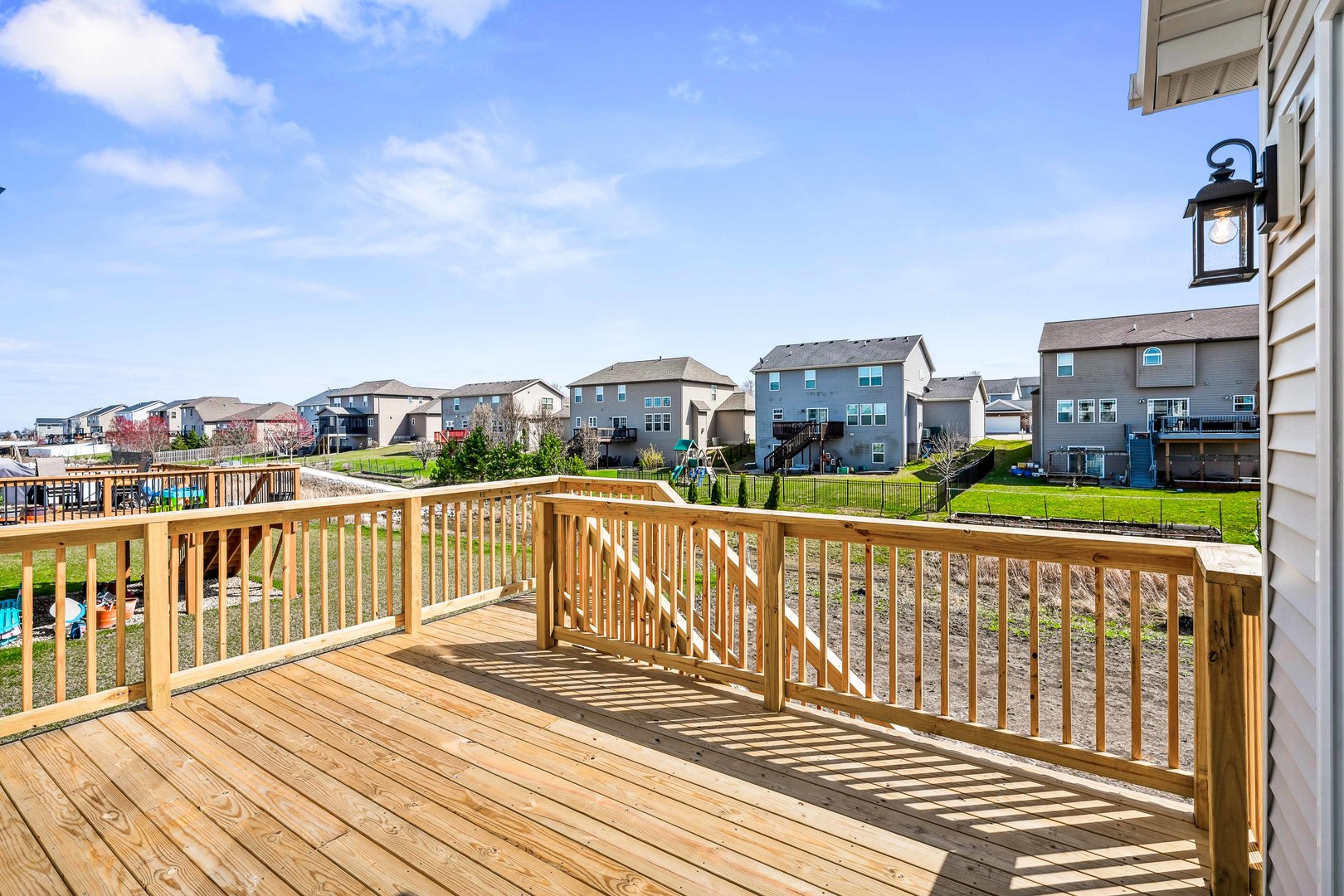 5017 Finlen Lane Bloomington, IL 61705 - Photo 57 of 60 a view of a balcony with wooden floor and city view