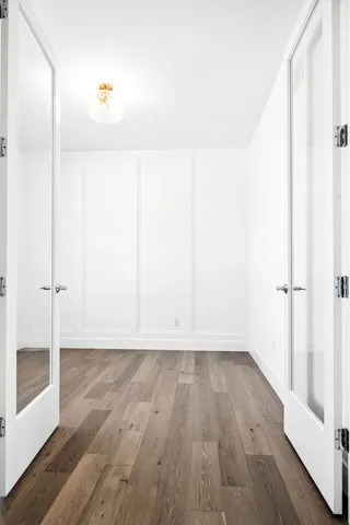 a view of wooden floor and windows in a room