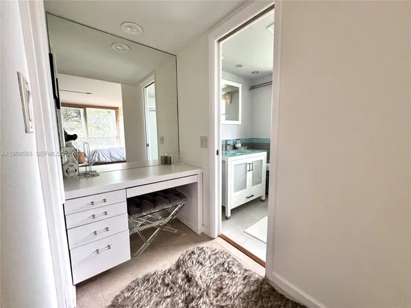 a hallway with cabinets and wooden floor