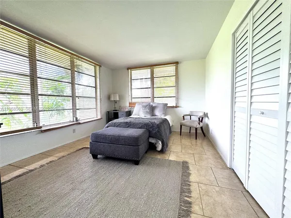 a spacious bedroom with a bed and a large window
