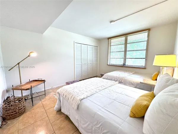 a bedroom with a bed chair and window