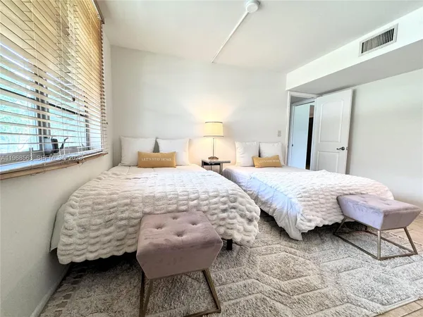 a bedroom with a bed and a night stand