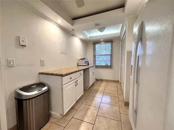 a kitchen with granite countertop a sink stove and cabinets