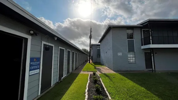 a view of backyard of house and car parked