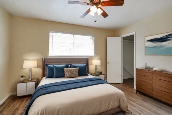 a bedroom with a large bed and a chandelier