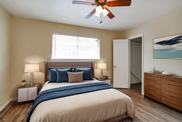 427 Hollyvale Drive, Unit 24 Houston, TX 77060 - Photo 8 of 9 a bedroom with a large bed and a chandelier