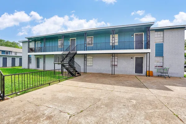 a front view of a house with a garden and garage