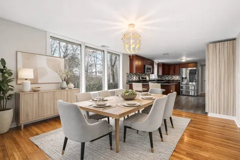 a view of a dining room with furniture window and wooden floor
