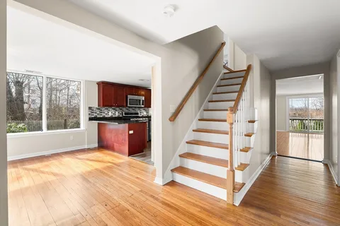 a view of kitchen with wooden floor and electronic appliances