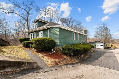 a view of a house with a yard covered in snow