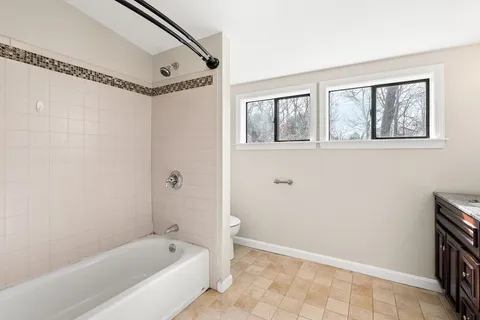 a bathroom with a bathtub and a shower