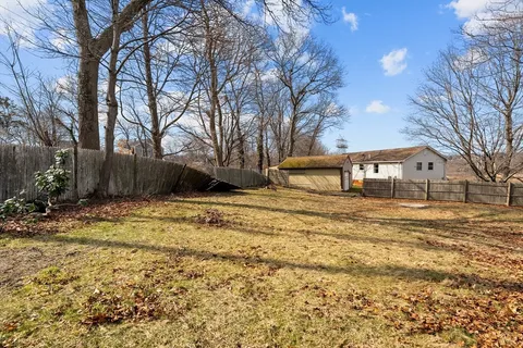 a view of a house with a yard and garage