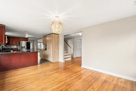 a view of a room with wooden floor and window