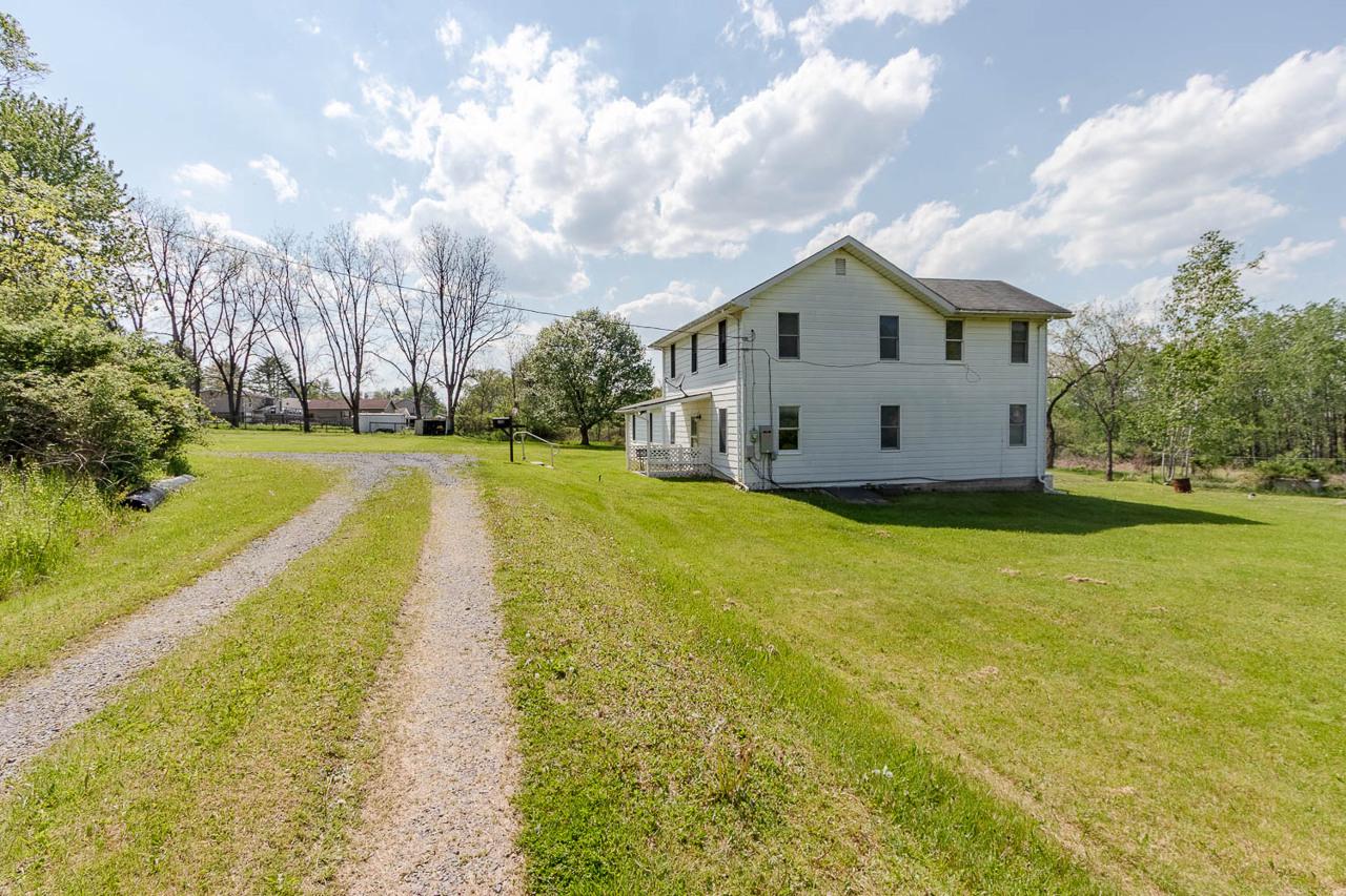 203 Gorton Road Moshannon, PA 16859 - Photo 3 of 39 a view of a white house with a big yard and large trees