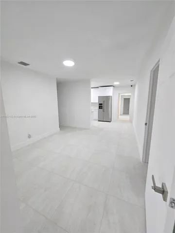 an empty room with white walls and white walls