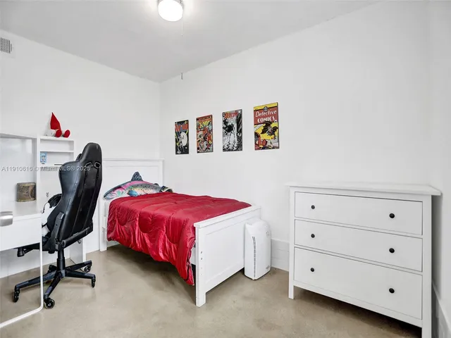 a bed room with a bed and a chair