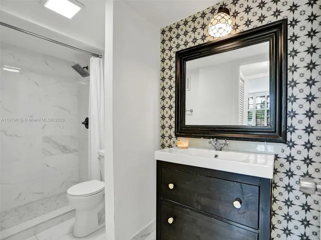 a bathroom with a toilet and shower