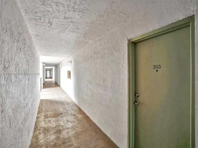 a view of a hallway and a window with balcony