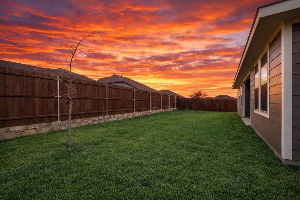 812 Primrose Lane Pilot Point, TX 76258 - Photo 23 of 23 a view of a backyard with wooden fence
