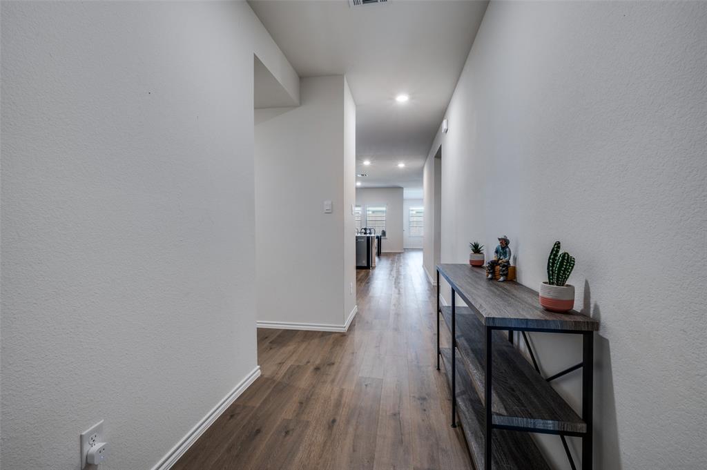 812 Primrose Lane Pilot Point, TX 76258 - Photo 3 of 23 a view of a room with wooden floor and furniture
