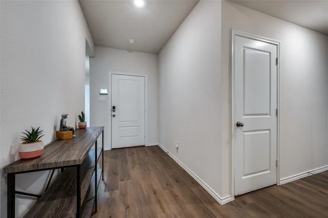 a very nice looking hallway with wooden floor