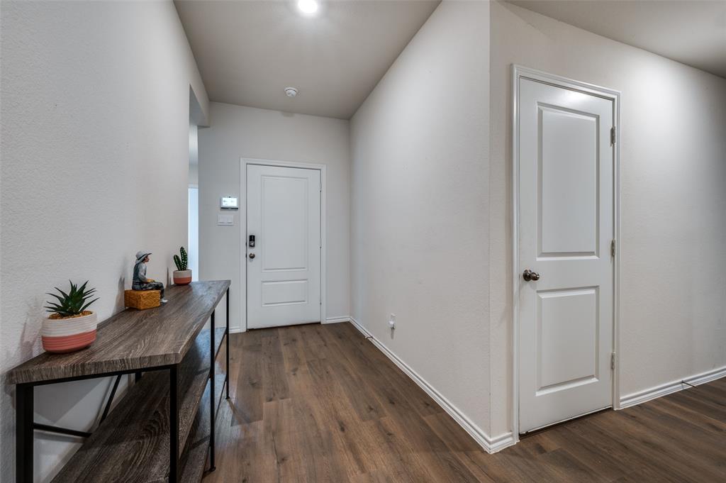 812 Primrose Lane Pilot Point, TX 76258 - Photo 4 of 23 a very nice looking hallway with wooden floor