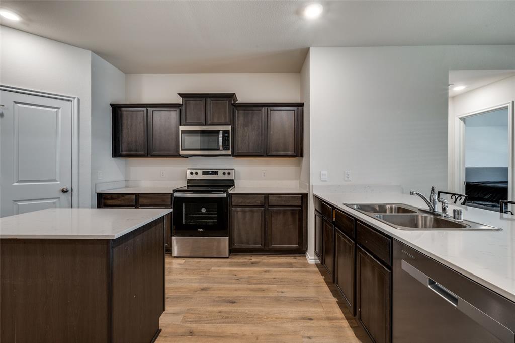812 Primrose Lane Pilot Point, TX 76258 - Photo 6 of 23 a kitchen with a sink stove top oven and refrigerator