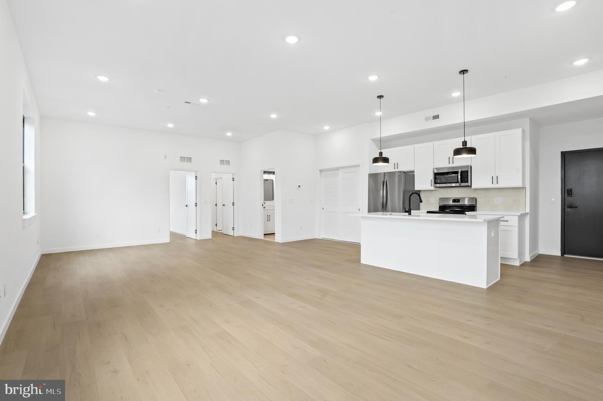 3211 Cedar Street, Unit 402 Philadelphia, PA 19134 - Photo 2 of 21 a view of kitchen with kitchen island and stainless steel appliances